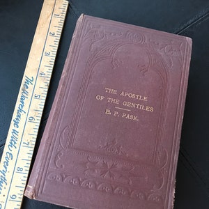 May include: A brown book with gold lettering on the cover. The title is "The Apostle of the Gentiles" by B. P. Pask.
