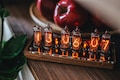 IN-14 Nixie clock in slim perforated wooden case with clear plastic top cover.
