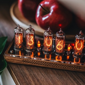 IN-14 Nixie clock in slim perforated wooden case with clear plastic top cover.