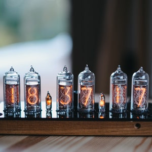 IN-14 Nixie clock in slim wooden enclosure with a plastic top cover.