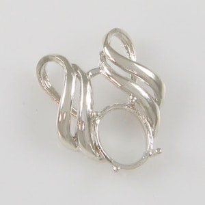 May include: A silver-colored pendant setting with an oval-shaped bezel. The setting features a swirling, ribbon-like design around the bezel, creating an open, airy look. The pendant is designed to hold a gemstone or other decorative element.