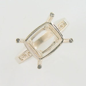 May include: Silver ring setting with a rectangular shaped center stone setting and small accent stones on the band.