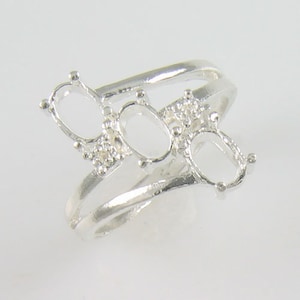 May include: Silver ring setting with three oval-shaped gemstone settings. The ring is designed with a double band.