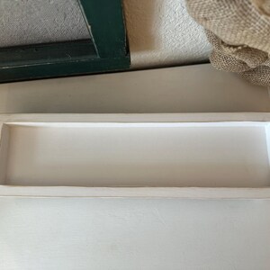 Rustic handcrafted wooden tray with smooth edges and a natural finish, available in customizable colors. The tray features a simple elegant design, perfect for serving as a decorative piece in any room.