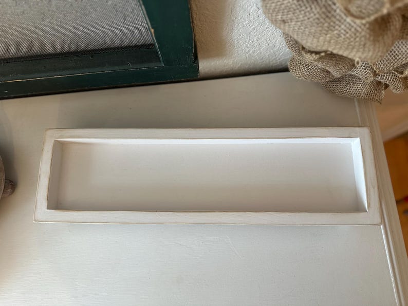 Rustic handcrafted wooden tray with smooth edges and a natural finish, available in customizable colors. The tray features a simple elegant design, perfect for serving as a decorative piece in any room.