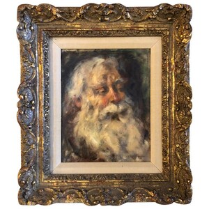 May include: A framed oil painting of a man with a long white beard. The painting is in a gold frame with ornate details. The man's face is partially obscured by his beard, but his eyes are visible and appear to be looking down.
