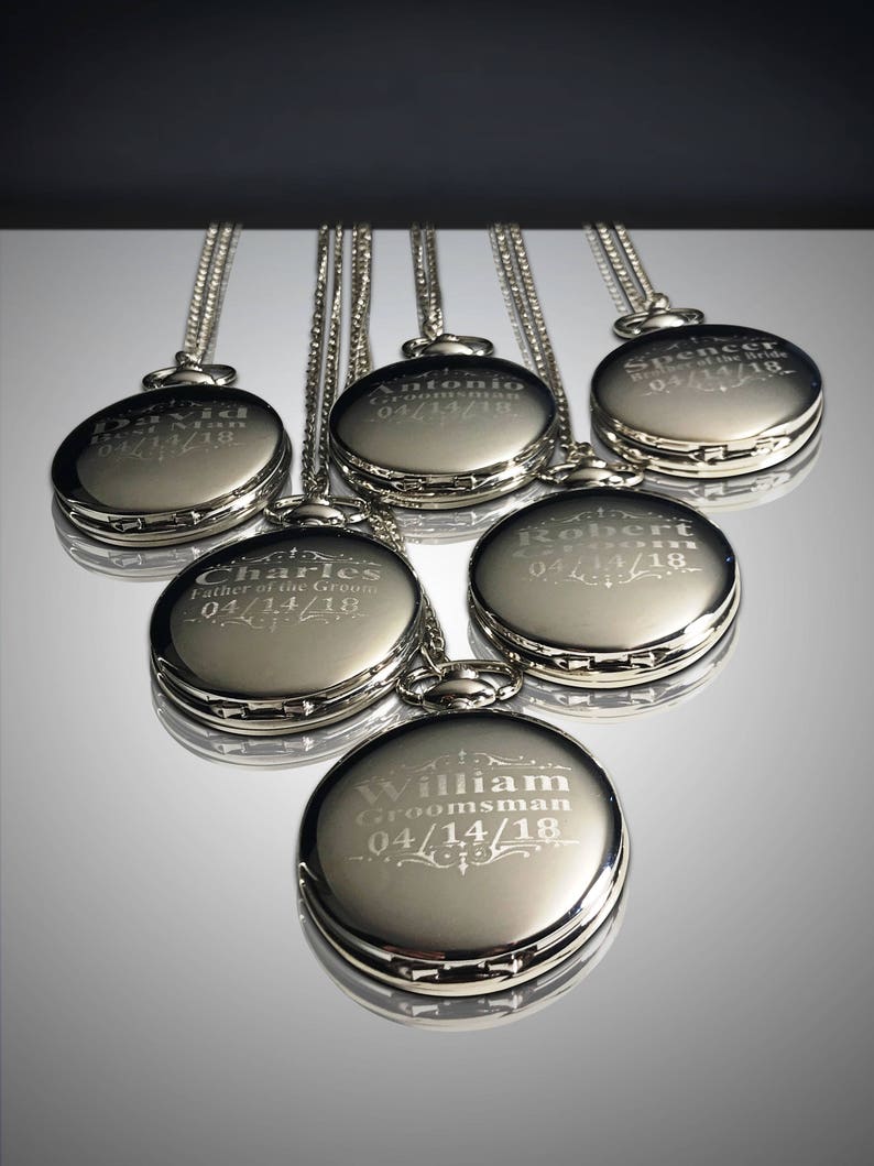 May include: Six silver pocket watches with engraved names and dates. The watches are on chains and arranged in a fan shape.