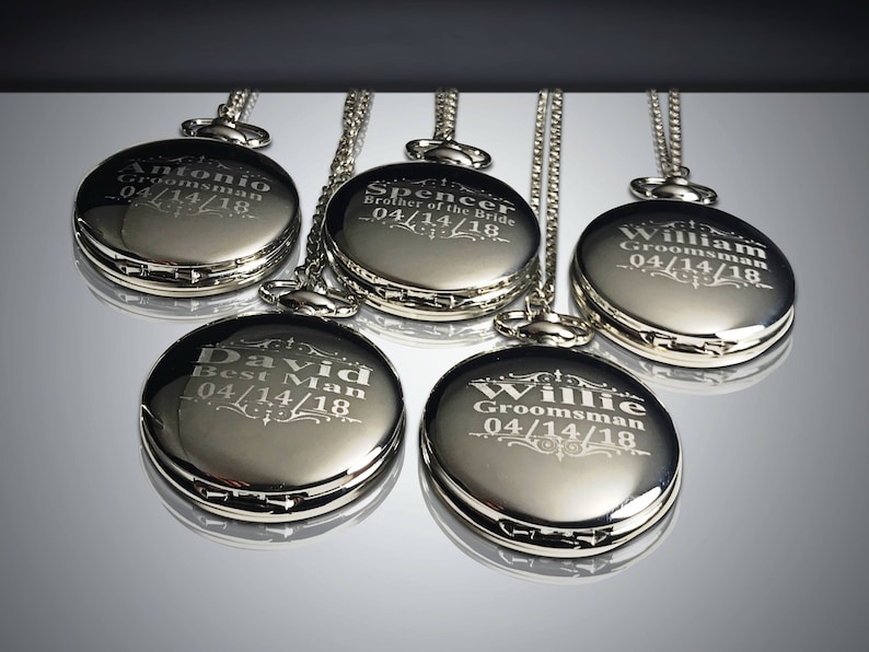 May include: Five silver pocket watches with chains, each engraved with a different name and the date 04/14/18. The names are Antonio, Spencer, William, David, and Willie.
