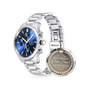 May include: A silver chronograph watch with a blue face and a stainless steel band. The back of the watch has an engraved message that reads "To My Best Friend Brian Hayes Best Man Today, Best Friend Forever 10/29/2023".