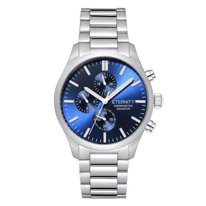 May include: A silver chronograph watch with a blue face and silver hands. The watch has a silver metal band and the words "ETERNITY CHRONOMETRIC NAVIGATOR" printed on the face.