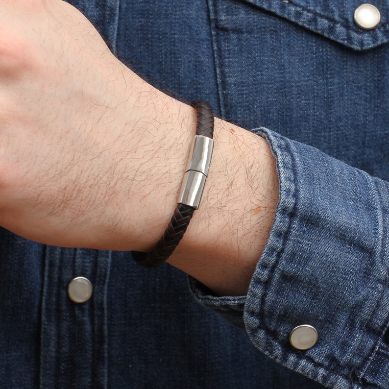 May include: A brown leather bracelet with a silver magnetic clasp.