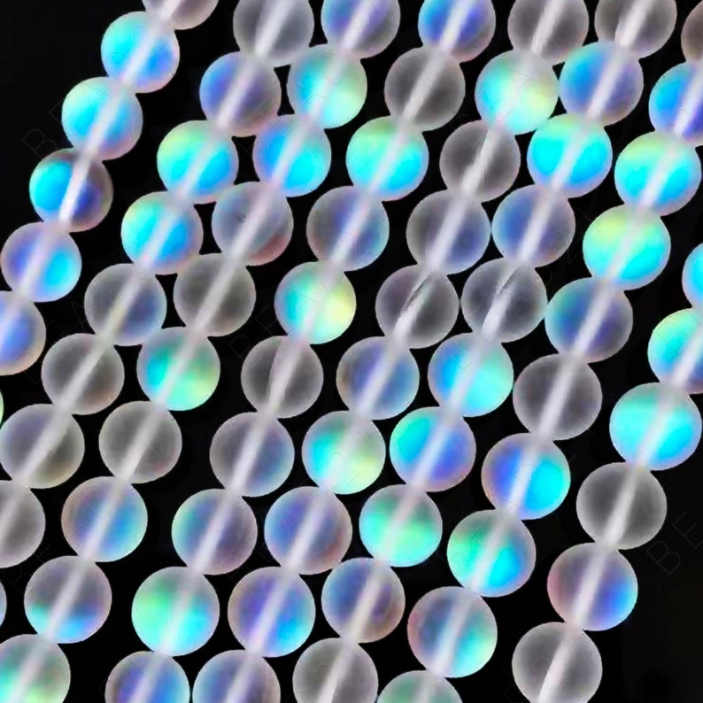 May include: A strand of iridescent white glass beads. The beads are round and have a frosted finish. They are strung on a clear thread.