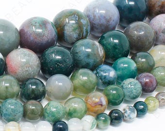 May include: A strand of round, green, brown, and white agate beads. The beads are various sizes and have a mottled, natural appearance.