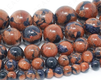 May include: A strand of round, brown and blue gemstone beads. The beads have a speckled, glittery appearance.