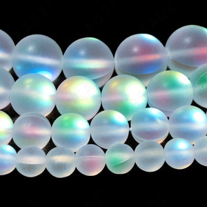 May include: A strand of iridescent white glass beads. The beads are round and have a frosted finish. They are strung on a clear thread.