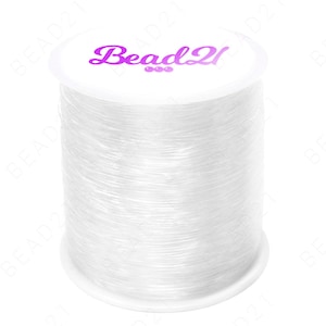 May include: A spool of clear elastic beading thread, wound on a white plastic spool with the label "Bead2u" in purple text.