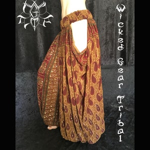 May include: Brown and maroon paisley print harem pants. The pants have an elastic waistband and a loose, flowing design. The words "Wicked Gear Tribal" are written vertically on the right side of the image.