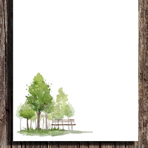 May include: Watercolor illustration of a park scene with green trees and a bench on a white background. The artwork is set against a rustic wooden backdrop, creating a contrast between the natural elements and the clean white space.