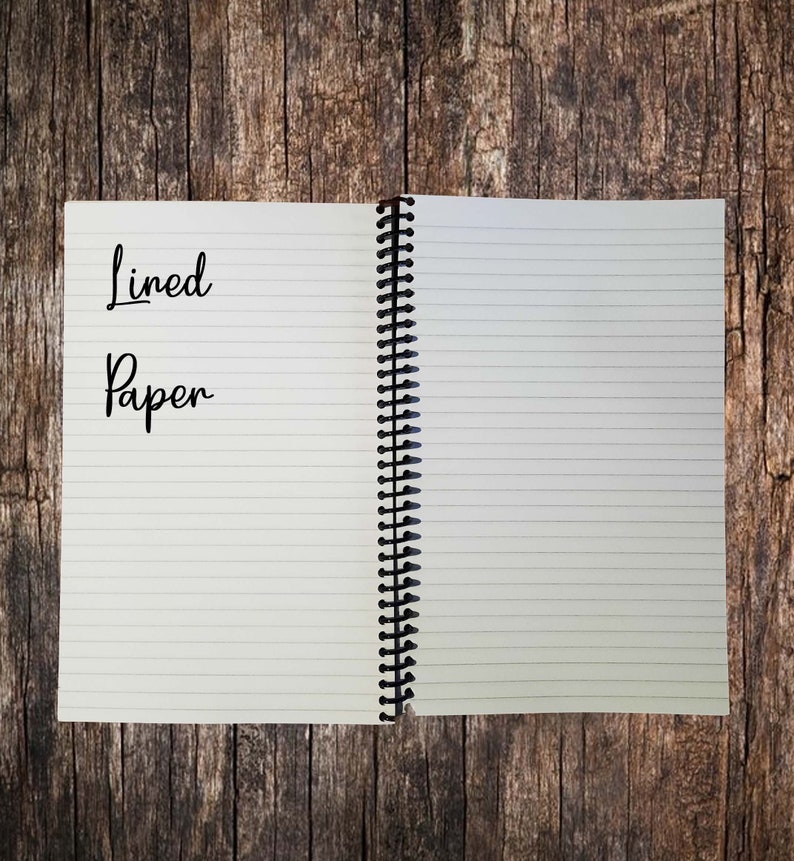 May include: An open spiral bound notebook with lined paper. The front cover has the words "Lined Paper" written in black ink.
