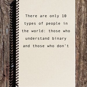 May include: A notebook with a spiral binding and a quote about binary code. The quote reads: "There are only 10 types of people in the world: those who understand binary and those who don't."