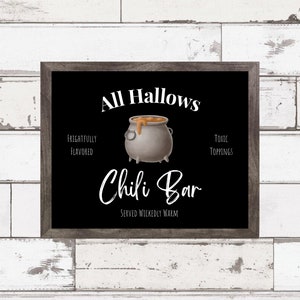 May include: A black and white sign with the text "All Hallows Chili Bar" and a cauldron with orange chili inside. The text "Frightfully Flavored" and "Toxic Toppings" are also on the sign.
