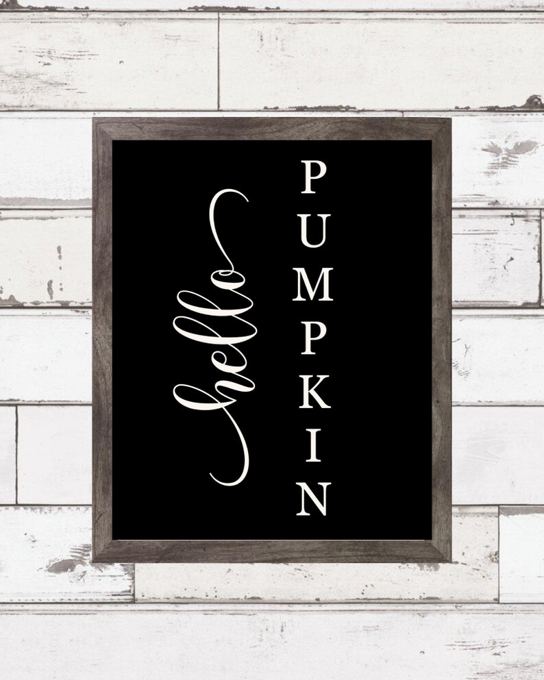 May include: Black and white sign with the text "hello" in a cursive font and the word "pumpkin" spelled vertically with each letter on a separate line.