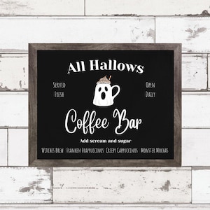May include: A black chalkboard sign with white text that reads "All Hallows Coffee Bar". The sign has a ghost-shaped coffee cup with whipped cream and a straw on top. The text "Served Fresh" is on the left side of the sign and "Open Daily" is on the right side. The text "Add scream and sugar" is below the coffee cup. Below that, the sign lists different coffee drinks: "Witches Brew", "Franken Frappuccinos", "Creepy Cappuccinos", and "Monster Mochas".