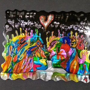 May include: A metal wall art piece depicting two abstract faces in a passionate embrace. The faces are surrounded by colorful, swirling patterns and a large heart shape. The background is black with a pattern of smaller hearts.