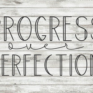 May include: Black and white text on a woodgrain background that reads "PROGRESS over PERFECTION".