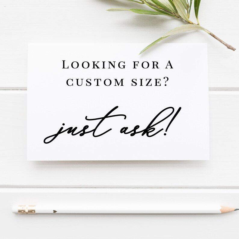 May include: A white card with the text "LOOKING FOR A CUSTOM SIZE? just ask!" in black. A white pencil is at the bottom of the card. Greenery is at the top right of the card. The background is white.