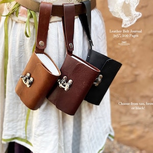 May include: Three leather belt journals in tan, brown, and black, each with a metal clasp. The journals are 3x5 inches and have 200 pages. The text reads: Leather Belt Journal 3x5", 200 Pages. Choose from tan, brown, or black!