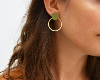 May include: A pair of gold hoop earrings with a green geometric shape attached to the top of each hoop.