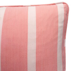 May include: A pink and white striped cushion with a subtle herringbone pattern. The cushion has white piping around the edges.