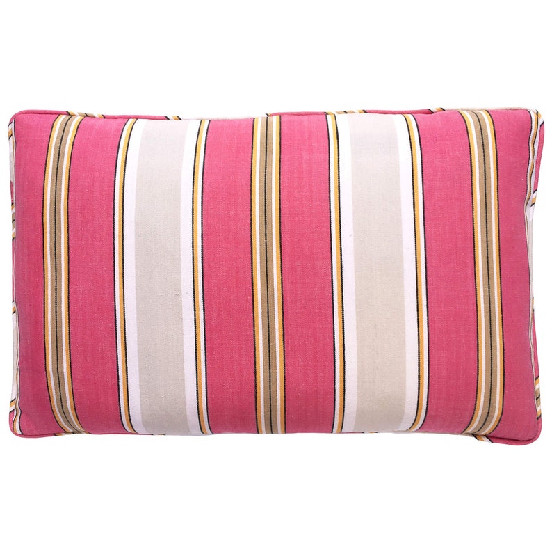 May include: A pink and white striped throw pillow with brown and yellow stripes. The pillow is made of a soft, woven fabric.