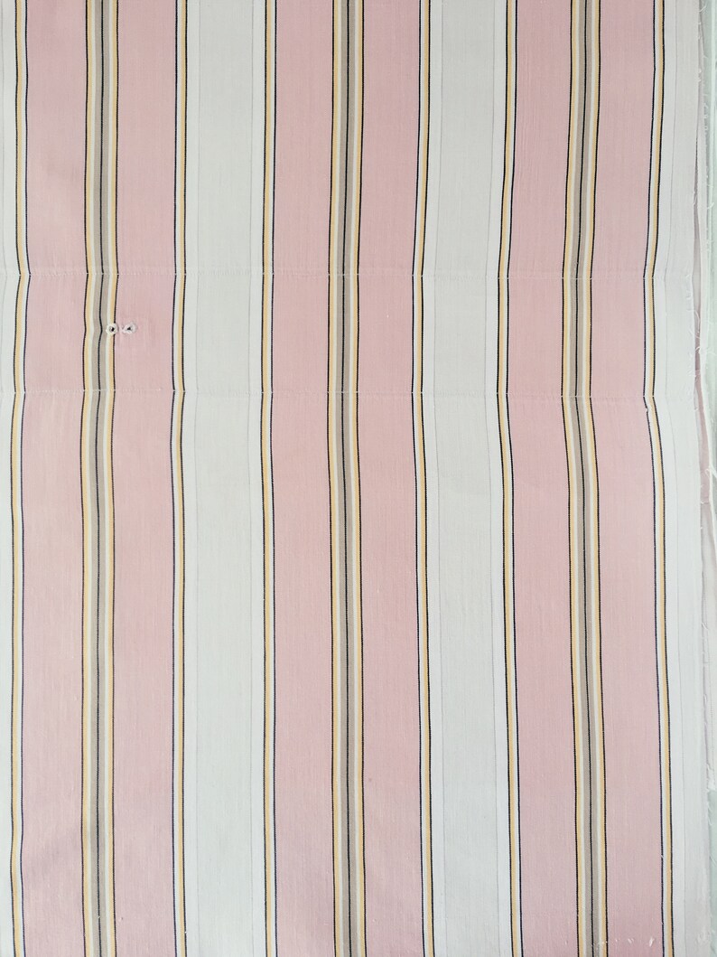 May include: Pink and white striped fabric with thin yellow and brown stripes.