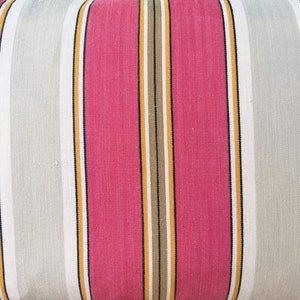 May include: Striped fabric with alternating bands of pink, white, yellow, and brown. The fabric has a subtle texture.