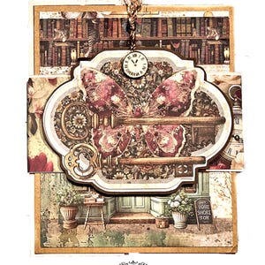 May include: A layered paper craft featuring a key-shaped design with a butterfly motif. The design incorporates floral and library imagery, a small clock, and the text "BUTTON FARM". The color palette includes shades of brown, cream, and burgundy.