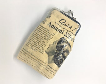 May include: Vintage Amami Wave Set coin purse with a silver clasp. The purse features a sepia-toned advertisement with text and an illustration of a woman with styled hair. The text includes "Quick! Amami Waves".