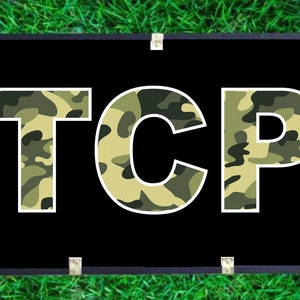 May include: A black banner with the word "TCP" in white letters. The letters are filled with a camouflage pattern in shades of green and tan.