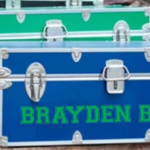 May include: A blue and green storage trunk with the name "Brayden Boyd" written in green letters.