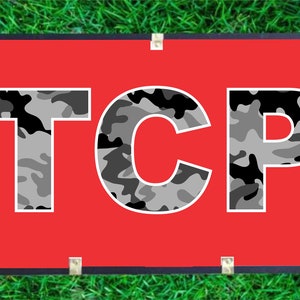 May include: A red banner with the word "TCP" in white letters with a camouflage pattern.