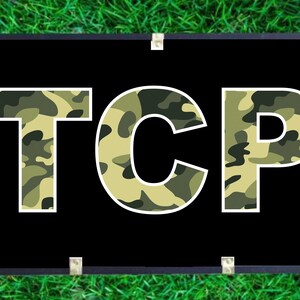 May include: A black banner with the word "TCP" in white letters. The letters are filled with a camouflage pattern in shades of green and tan.