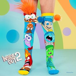May include: A pair of blue knee-high socks with a colorful graphic print of characters from the Disney Pixar movie Inside Out 2. The socks feature Joy, Sadness, Anger, Fear, and Disgust.