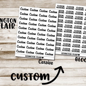 May include: Two sheets of custom stickers with the text "Custom" and "Custom Wording" in cursive and block fonts. The "Lexington Flair" logo is visible. The stickers are on a light wood grain background.