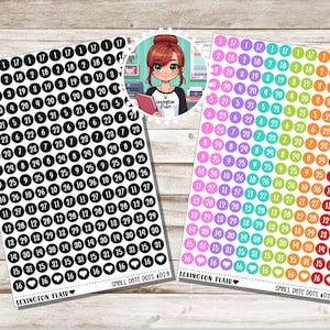 May include: Two sheets of colorful round stickers with numbers 1 through 31 and a heart symbol. The stickers are arranged in rows and columns. The stickers are on a wooden background. The text "Lexington Flair" and "Small Date Dots #D28" is printed on the sheets.