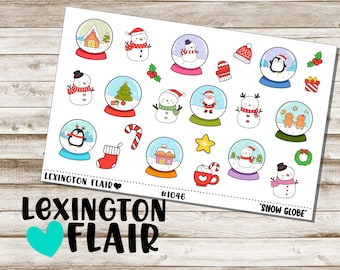 May include: A sheet of colorful stickers featuring winter holiday themed snow globes. The stickers include penguins, snowmen, Santa Claus, candy canes, and a gingerbread house. The text "Lexington Flair" and "Snow Globe" are also included.
