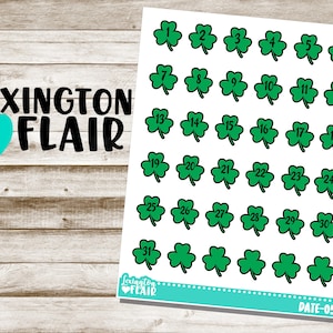 May include: A sheet of 31 green shamrock stickers with black numbers 1 through 31. The stickers are on a white background. The sheet has the text "Lexington Flair" at the bottom.