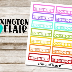 May include: A set of 8 colorful printable planner stickers with the text "MTWTFSS" in white. The stickers are in a rainbow of colors: pink, purple, light blue, turquoise, yellow, orange, and red.
