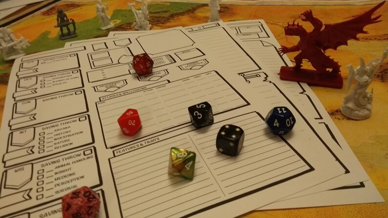 May include: A tabletop role-playing game setup with character sheets, dice, and miniature figurines. The dice are various colors, including red, black, and blue. A red dragon figurine and white figurines are also present.