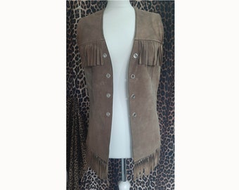 May include: A brown suede vest with fringe detailing and a button closure.